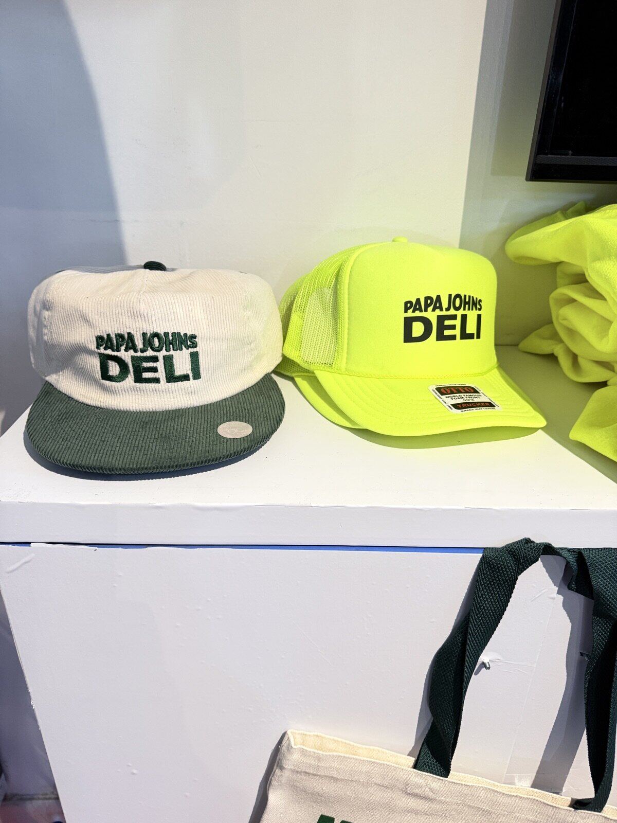 Wall of freshly printed branded merch at a live activation